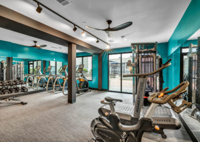 gym with amenities at the quarters on campus apartments