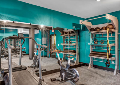 gym equipped with amenities at the quarters on campus apartments