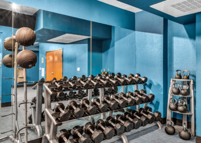 free weights inside the gym at the quarters on campus apartments